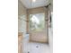 Glass enclosed walk-in shower features neutral tiling, shower head, and seat at 2191 Flowering Dr, Grayson, GA 30017