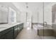 Modern bathroom features dual sinks, a soaking tub, and a glass-enclosed shower at 3460 Austin Michael Ln, Cumming, GA 30028