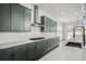 Modern kitchen with stainless steel appliances, stylish backsplash, and a large sink at 3460 Austin Michael Ln, Cumming, GA 30028