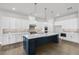 Beautiful kitchen boasting white cabinets, quartz countertops, a center island with a sink, and modern appliances at 3460 Austin Michael Ln, Cumming, GA 30028