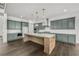 Spacious kitchen with sleek, gray cabinetry, a large island, and hardwood floors at 3460 Austin Michael Ln, Cumming, GA 30028