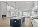 Open-concept kitchen with a large island, stainless steel appliances, and seamless connection to the living area at 3460 Austin Michael Ln, Cumming, GA 30028