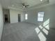 Spacious main bedroom with a tray ceiling, carpeted floors, and lots of natural light at 3460 Austin Michael Ln, Cumming, GA 30028