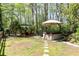 Relaxing backyard oasis with hot tub, outdoor seating, and a tranquil wooded setting perfect for outdoor entertaining at 386 Collegiate Dr, Powder Springs, GA 30127