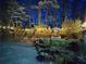 Backyard featuring a hot tub and outdoor seating area illuminated with enchanting string lights at night at 386 Collegiate Dr, Powder Springs, GA 30127