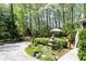 Beautifully landscaped backyard with a fountain and outdoor seating perfect for entertaining and enjoying nature at 386 Collegiate Dr, Powder Springs, GA 30127