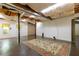 Unfinished basement with open ceiling and large rug, perfect for customization at 386 Collegiate Dr, Powder Springs, GA 30127