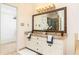 Bathroom featuring dual sinks, granite countertops, and walk-in closet access at 386 Collegiate Dr, Powder Springs, GA 30127