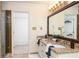 Bathroom featuring double vanity with granite countertops and a tiled shower stall at 386 Collegiate Dr, Powder Springs, GA 30127