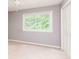 Well-lit bedroom featuring a ceiling fan, window, and closet at 386 Collegiate Dr, Powder Springs, GA 30127