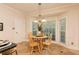 Bright breakfast nook features a bay window and a charming round table at 386 Collegiate Dr, Powder Springs, GA 30127