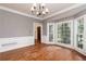 Elegant dining room featuring hardwood floors, wainscoting, and a bay window at 386 Collegiate Dr, Powder Springs, GA 30127
