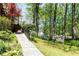 Well-maintained home exterior with landscaped walkway, stairs, and a view of the beautiful yard at 386 Collegiate Dr, Powder Springs, GA 30127