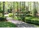 Lovely two-story home featuring a circular driveway and lush landscaping at 386 Collegiate Dr, Powder Springs, GA 30127