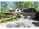 Charming home with a two-car garage, screened porch, and manicured garden at 386 Collegiate Dr, Powder Springs, GA 30127