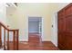 Warm foyer featuring hardwood floors, a staircase, and an inviting entrance at 386 Collegiate Dr, Powder Springs, GA 30127