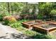 Beautiful garden featuring raised beds and colorful flowering shrubs at 386 Collegiate Dr, Powder Springs, GA 30127