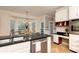 Well-lit kitchen with granite countertops, stainless steel appliances, and adjacent breakfast nook at 386 Collegiate Dr, Powder Springs, GA 30127