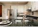 This kitchen has granite countertops, a stainless-steel refrigerator, and white cabinets at 386 Collegiate Dr, Powder Springs, GA 30127