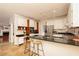 Bright kitchen with stainless steel appliances, granite counters, white cabinets, and an eat-in bar at 386 Collegiate Dr, Powder Springs, GA 30127