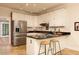 A kitchen with stainless steel appliances, white cabinets, granite counters, and an eat-in bar at 386 Collegiate Dr, Powder Springs, GA 30127
