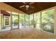 This is a view of the enclosed back porch with brick flooring, multiple doors, and screened windows at 386 Collegiate Dr, Powder Springs, GA 30127