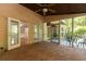 Enclosed porch with brick floor, ceiling fan, multiple doors and screened windows to allow outdoor enjoyment at 386 Collegiate Dr, Powder Springs, GA 30127