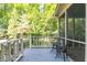 Relaxing screened porch featuring outdoor seating and a view of the serene backyard at 386 Collegiate Dr, Powder Springs, GA 30127