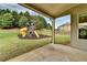 Backyard featuring a playground set, lush green grass, and a covered patio area at 3925 Sierra Knolls Ct, Cumming, GA 30040