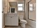 Bathroom with white vanity, toilet, and shower/tub combo with a window providing natural light at 3925 Sierra Knolls Ct, Cumming, GA 30040