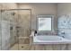 Beautiful bathroom with soaking tub and glass shower with marble tile at 3925 Sierra Knolls Ct, Cumming, GA 30040