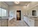 Beautiful bathroom featuring a large soaking tub, glass enclosed shower, and dual sink vanity with granite countertop at 3925 Sierra Knolls Ct, Cumming, GA 30040