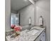Bright bathroom featuring a granite countertop, white cabinets, and a large mirror at 3925 Sierra Knolls Ct, Cumming, GA 30040