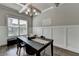 Elegant dining room with coffered ceiling, wainscoting, chandelier, and a large window at 3925 Sierra Knolls Ct, Cumming, GA 30040