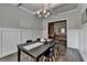 Elegant dining room with coffered ceiling, wainscoting, chandelier, and a large window at 3925 Sierra Knolls Ct, Cumming, GA 30040