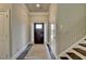 Inviting entryway featuring a dark front door, neutral walls, and a staircase with dark wood treads at 3925 Sierra Knolls Ct, Cumming, GA 30040