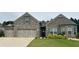 Charming brick home with a three-car garage, well-manicured lawn and lovely landscaping at 3925 Sierra Knolls Ct, Cumming, GA 30040
