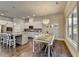 Kitchen and dining area with stainless appliances, pendant lighting and hardwood floors at 3925 Sierra Knolls Ct, Cumming, GA 30040
