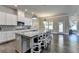 Bright open kitchen features a large center island with bar seating, sleek cabinetry and modern stainless steel appliances at 3925 Sierra Knolls Ct, Cumming, GA 30040