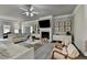 Bright living room features a fireplace, mounted television, and hardwood flooring at 3925 Sierra Knolls Ct, Cumming, GA 30040