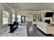Living room features hardwood floors, fireplace, and view into bedroom at 3925 Sierra Knolls Ct, Cumming, GA 30040