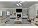 Bright living room features a fireplace, mounted television, and hardwood flooring at 3925 Sierra Knolls Ct, Cumming, GA 30040