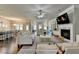 Spacious living room with a fireplace, hardwood floors, and an open floor plan leading to the kitchen at 3925 Sierra Knolls Ct, Cumming, GA 30040