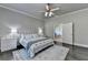 This bright main bedroom offers soft, neutral walls, dark hardwood floors, and calming decor at 3925 Sierra Knolls Ct, Cumming, GA 30040