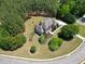 Stunning aerial view of the property showcasing meticulous landscaping and surrounding trees at 105 New Castle Ln, Tyrone, GA 30290