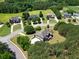 Wide aerial shot of the property and neighborhood with mature trees and landscaping at 105 New Castle Ln, Tyrone, GA 30290