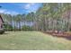 Expansive backyard with lush lawn and bordering trees creates a private oasis at 105 New Castle Ln, Tyrone, GA 30290