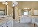 Bathroom showcasing double sinks, ample storage, and a large mirror at 105 New Castle Ln, Tyrone, GA 30290