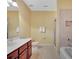 Well-appointed bathroom with double sinks, a tub and shower, and classic fixtures at 105 New Castle Ln, Tyrone, GA 30290