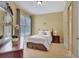 Cozy bedroom with neutral walls, carpet, a window, and dark wood furnishings at 105 New Castle Ln, Tyrone, GA 30290